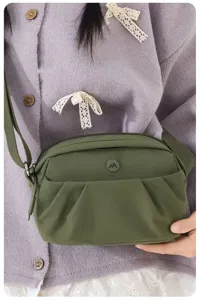 Casual green nylon crossbody bag for women, multi-layer zipper phone bag, stylish chic.