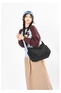 Casual black nylon crossbody bag with large capacity and multi pockets for daily commuter use.