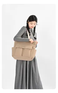 Large capacity nylon tote bag for women, stylish commuter shoulder bag with multiple pockets.