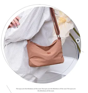 Detail view of casual water-resistant nylon crossbody bag with multi-layer design.