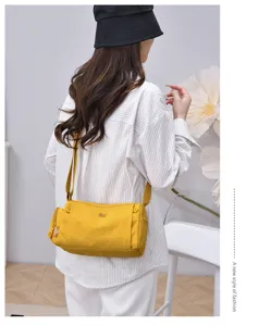 Stylish women multi-pocket canvas crossbody bag, casual yellow shoulder travel bag.