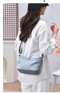 Casual nylon crossbody bag for women, multi-layer small shoulder bag, gray anti-splash design.