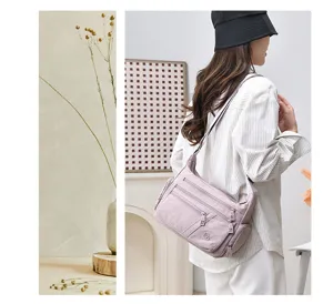 Lightweight purple multi-compartment crossbody shoulder bag detail view, casual daily use.