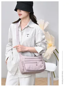 Casual multi-pocket nylon shoulder bag detail view, lightweight commuter crossbody.