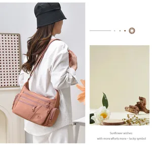 Casual multi-compartment shoulder bag detail showing zippers and durable fabric material.