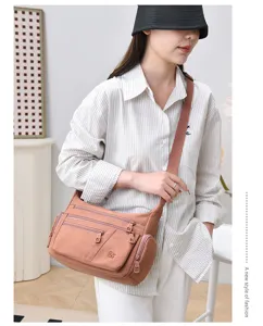 Casual multi-pocket nylon crossbody shoulder bag for women, stylish commuting handbag.