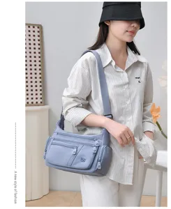 Detail view of casual women multi-compartment shoulder bag, stylish commuter crossbody bag.