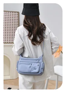 Detailed view of the stylish women's multi-compartment shoulder bag, casual everyday commuter bag.