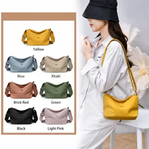 Multilayer casual nylon crossbody bag for women, waterproof solid color shoulder bag.