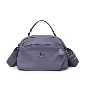 Stylish casual purple nylon crossbody bag with top handle, multi-layer design, and convenient storage.