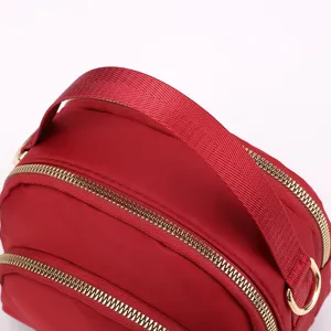Red fabric women crossbody shoulder handbag with gold zippers compact design stylish daily wear