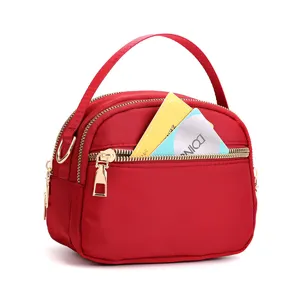 Red nylon small crossbody bag for women with multi zipper pockets and top handle