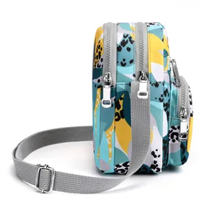 Multi-pocket nylon crossbody bag for women, casual print shoulder bag with zipper.