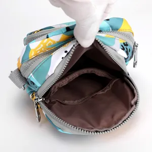 Trendy printed nylon crossbody bag with multi-zipper compartments and spacious interior.