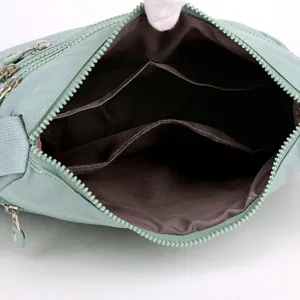 Green oxford cloth multi-layer crossbody shoulder bag for women, spacious interior view.