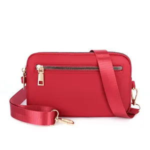 Red nylon crossbody shoulder bag for women, travel small square bag with front zipper.
