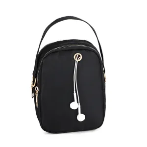 Nylon crossbody bag for women, lightweight mini shoulder bag with headphone hole and top handle.