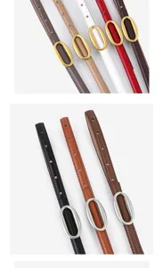 Detailed view of women thin cowhide leather belt with elegant oval metal buckle for jeans.