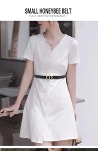 Detailed view of women's black leather belt with gold metal buckle, stylish and versatile accessory.