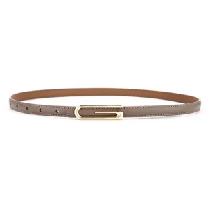Detailed view of women's narrow taupe leather belt with elegant gold-tone metal buckle.
