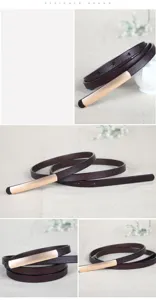 Thin women leather dress belt detail view, elegant dark brown strap with gold metal buckle.