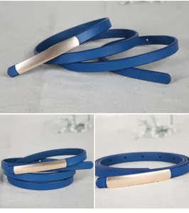 Close-up detail showing the blue leather thin belt with elegant gold metal plate buckle.