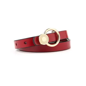 Red leather belt detail featuring a stylish gold circular metal ring buckle design.