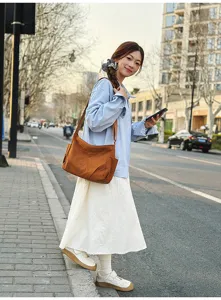 Casual brown nylon shoulder bag in street scene, lightweight casual daily use accessory.