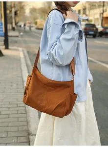 Casual nylon shoulder messenger bag for women, large capacity daily tote with side pockets.
