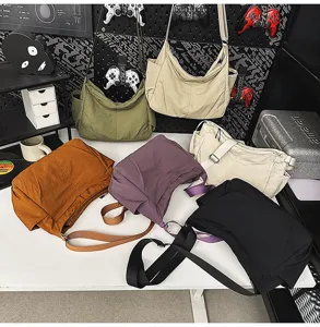 Detailed view of large capacity casual nylon shoulder bag showing multiple colors and durable straps.