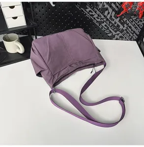 Detail view of the large capacity purple nylon shoulder crossbody bag showing casual style.