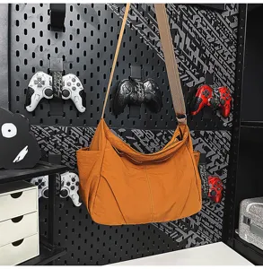 Casual orange nylon shoulder crossbody bag with large capacity and lightweight daily use.
