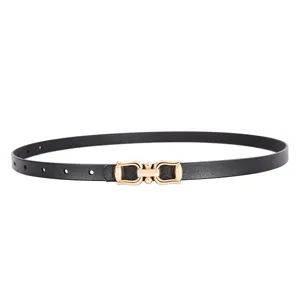 Detail view of a sleek black leather women belt with a stylish gold metal buckle fashion.