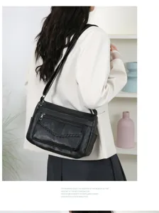 Fashionable black leather women's shoulder bag with multi-pockets for travel and daily use.
