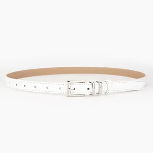 Minimalist white leather belt with silver pin buckle, elegant casual jeans accessory detail.