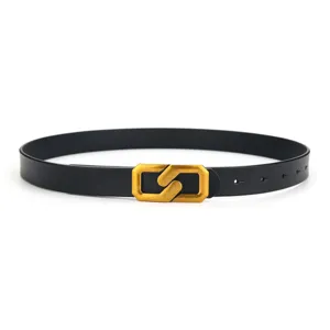 Detailed close-up of a minimalist black leather belt featuring a distinct gold geometric buckle.