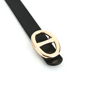 Women black leather belt with elegant gold oval metal buckle, fashion waist accessory.