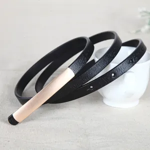 Women thin black leather belt with gold metal buckle coiled main product view for dresses.