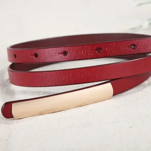 Women thin leather dress belt with smooth metal buckle, wine red waist accessory for daily wear.