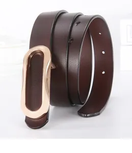 Detail shot of women's brown leather belt featuring a sleek gold oval buckle design.