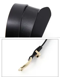 Detail close-up of a stylish black women leather belt with unique gold metal buckle design.