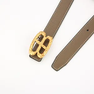 Women leather belt with stylish textured gold buckle and contrast stitching for daily wear.