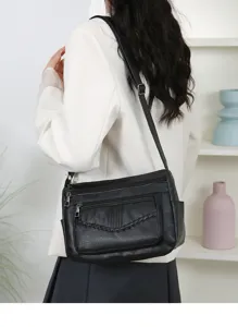 Black multi-pocket faux leather women shoulder bag with braided detail and adjustable strap.