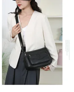 Stylish women's black PU leather cross-body bag with multiple zipper pockets and braided details.