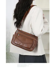 Detailed view of the stylish brown leather women shoulder bag with multi zipped pockets.