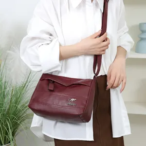 Stylish women's leather crossbody bag with adjustable strap and multi-pocket design.