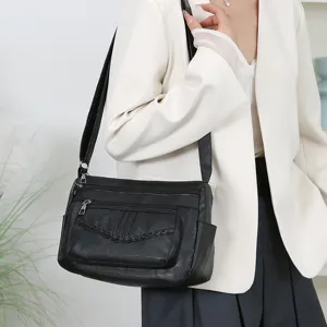 Stylish black multi-pocket women's crossbody shoulder bag for daily casual travel use.