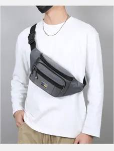 Detailed view of the multi-pocket grey chest bag worn by model, highlighting waterproof fabric.