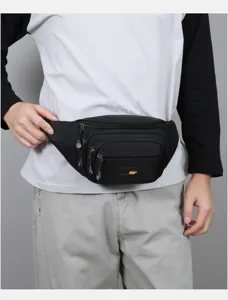 Detail view of black nylon waist bag with multiple zip pockets for outdoor sports and travel.