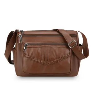 Stylish women brown PU leather crossbody shoulder bag with multi zipper pockets and braided detail.